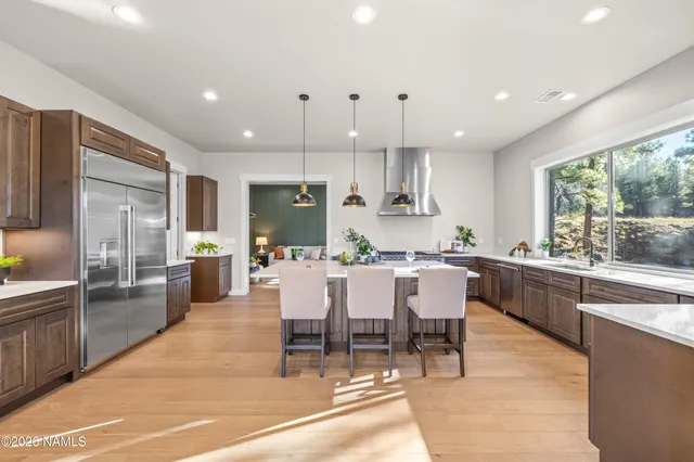 a living room with furniture a piano and a window
