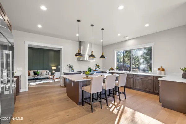 a living room with furniture kitchen view and a flat screen tv