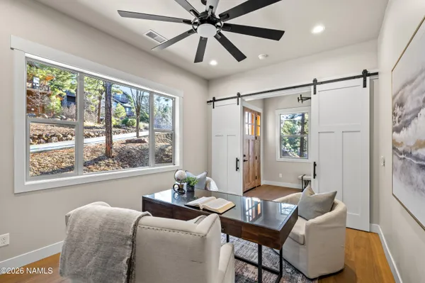 an empty room with a window and a fan