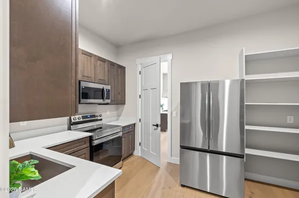 an empty room with ceiling fan and window