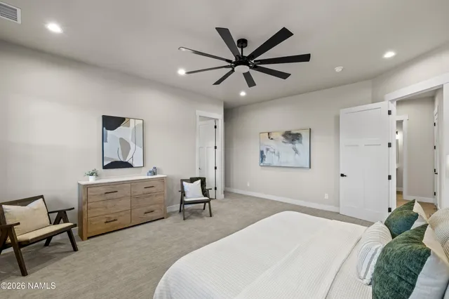 an empty room with ceiling fan and window