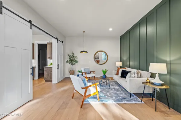 a kitchen with kitchen island a large counter top space a sink stainless steel appliances and a large window