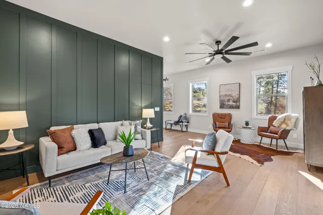 a kitchen with kitchen island a large counter top space a sink stainless steel appliances and a large window