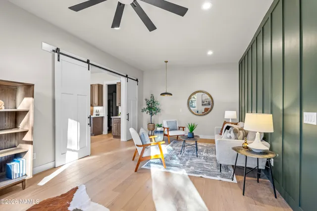 a large kitchen that has a lot of cabinets a sink a window and stainless steel appliances