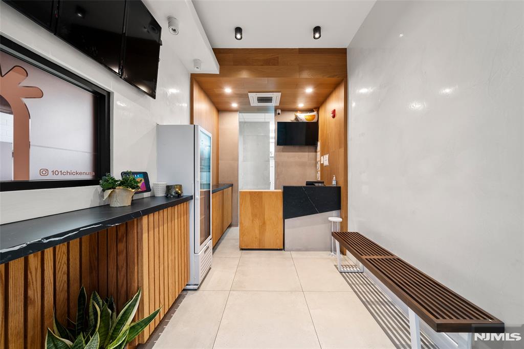 69-71 Ridgefield Avenue Ridgefield Park, NJ 07660 - Photo 12 of 37 a view of a hallway with wooden floor and staircase