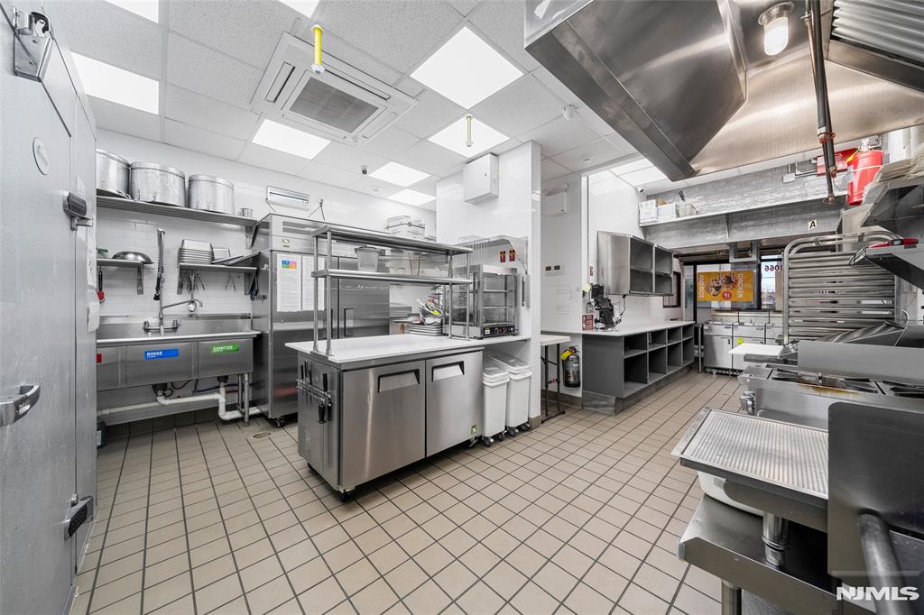 69-71 Ridgefield Avenue Ridgefield Park, NJ 07660 - Photo 13 of 37 a kitchen with cabinets and chairs