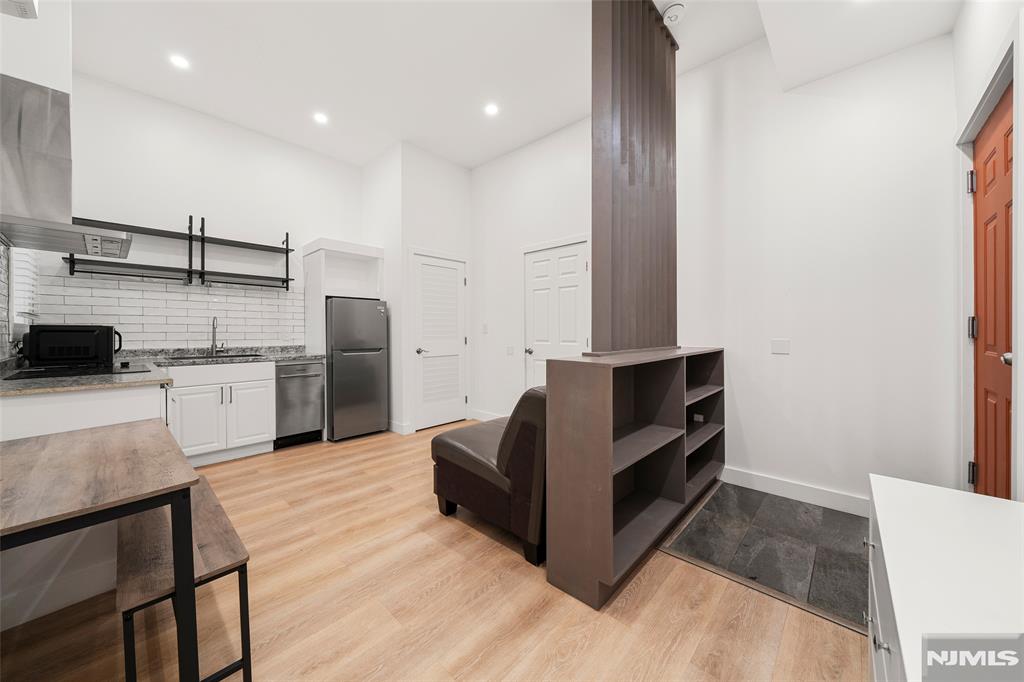 69-71 Ridgefield Avenue Ridgefield Park, NJ 07660 - Photo 20 of 37 a kitchen with stainless steel appliances kitchen island granite countertop a refrigerator and a stove top oven