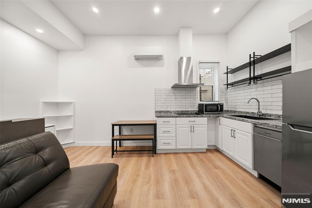 69-71 Ridgefield Avenue Ridgefield Park, NJ 07660 - Photo 21 of 37 a kitchen with stainless steel appliances granite countertop a refrigerator and a stove top oven
