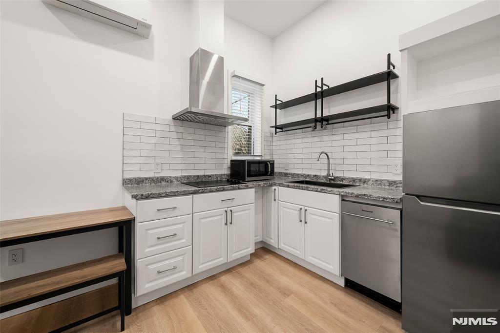 69-71 Ridgefield Avenue Ridgefield Park, NJ 07660 - Photo 22 of 37 a kitchen with stainless steel appliances granite countertop a sink and cabinets