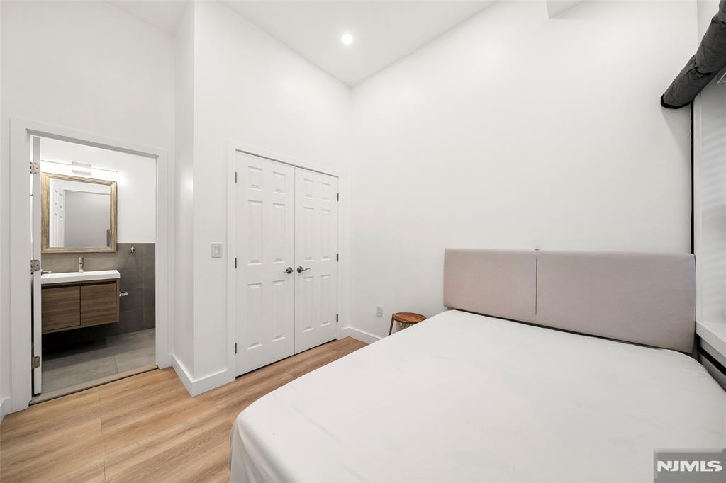 69-71 Ridgefield Avenue Ridgefield Park, NJ 07660 - Photo 26 of 37 a bedroom with a bed and a view of bathroom