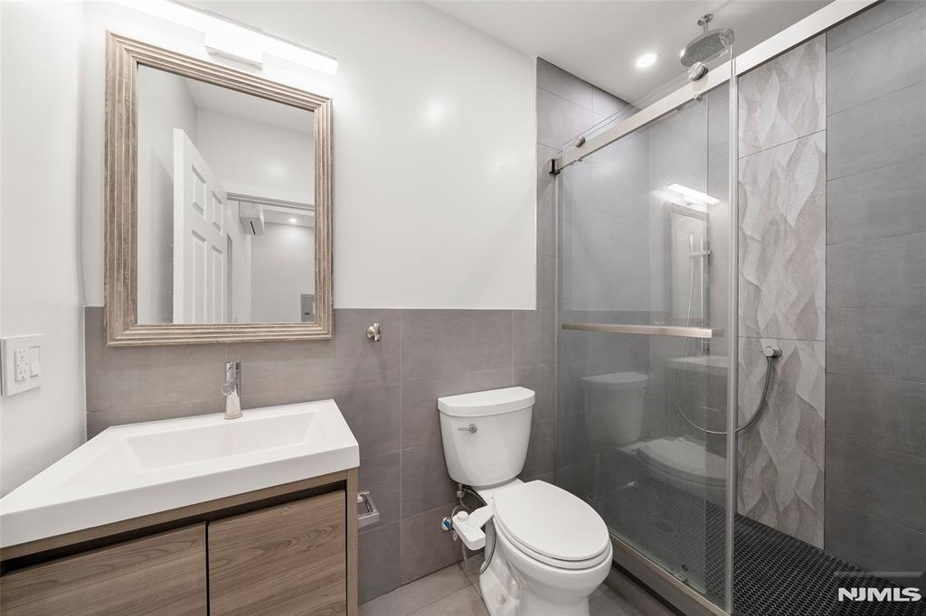 69-71 Ridgefield Avenue Ridgefield Park, NJ 07660 - Photo 27 of 37 a bathroom with a sink a toilet and shower