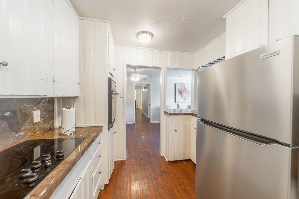 4723 Merwin Street Houston, TX 77027 - Photo 10 of 29 a kitchen with a refrigerator and a stove