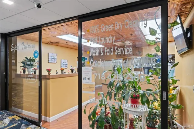 a view of a dining room with furniture and floor to ceiling window