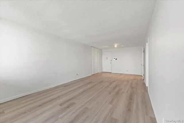 a view of an empty room and wooden floor