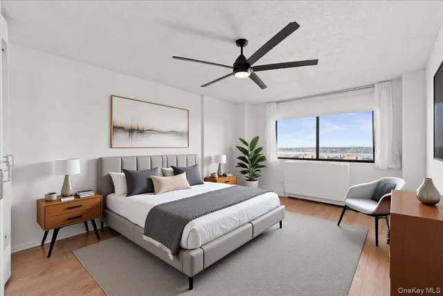 a bedroom with a large bed and a chandelier