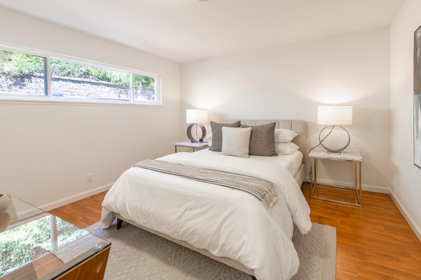 30432 Treeview Street Hayward, CA 94544 - Photo 24 of 35 a bedroom with a bed and wooden floor