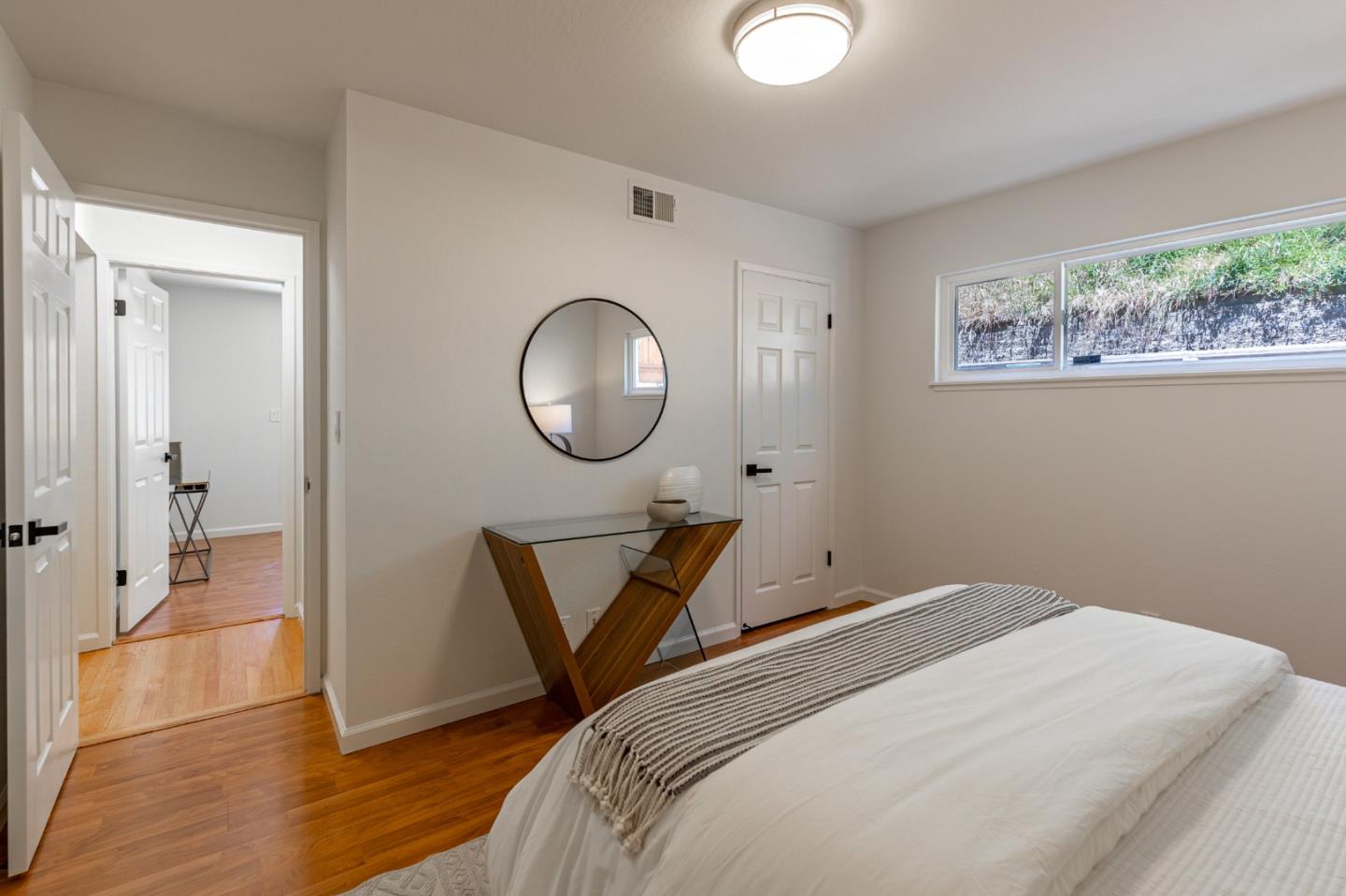 30432 Treeview Street Hayward, CA 94544 - Photo 25 of 35 a bedroom with a bed a mirror and a potted plant