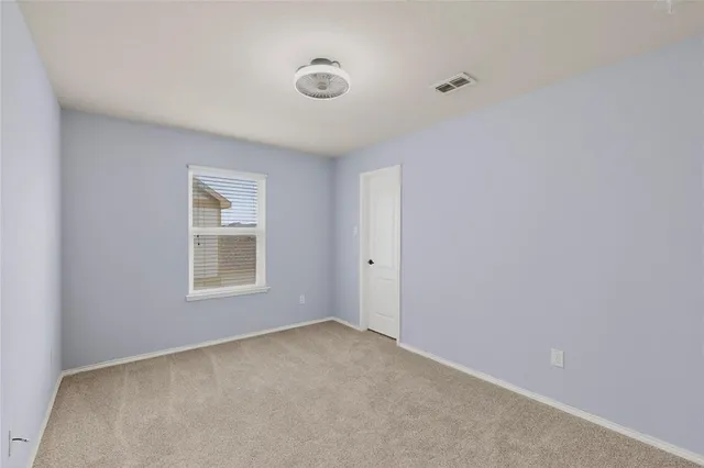 a view of an empty room and a window