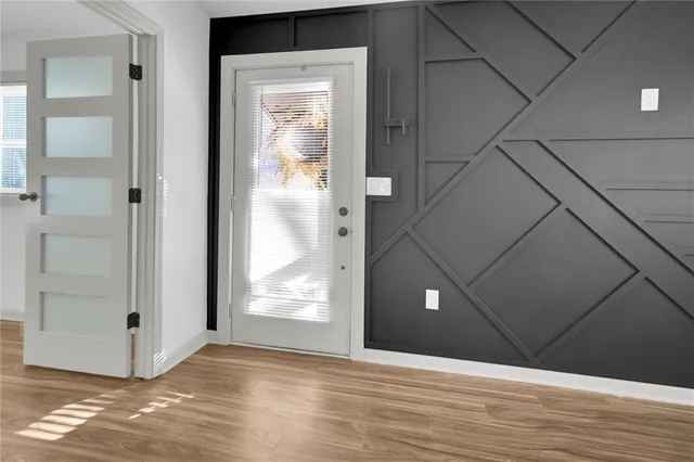 a view of a hallway with wooden floor