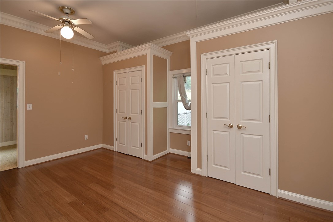 197 Deer Creek Road Easley, SC 29640 - Photo 31 of 50 Rich hardwood floors complement elegant crown molding and ample closet space in this inviting bedroom.