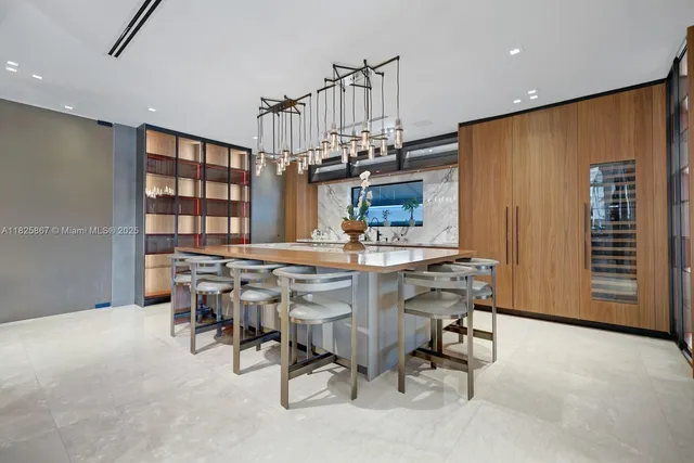 a view of a dining room with furniture a chandelier and a flat screen tv