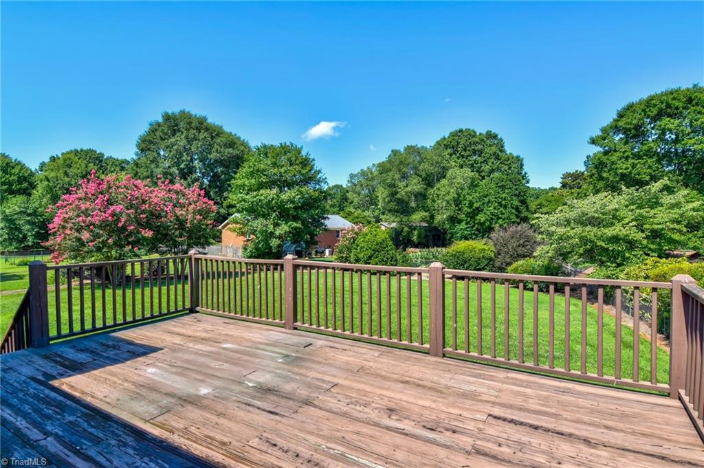 546 Drumheller Road Clemmons, NC 27012 - Photo 26 of 29 View from the back deck, overlooking the fully fenced backyard with elegant landscaping.