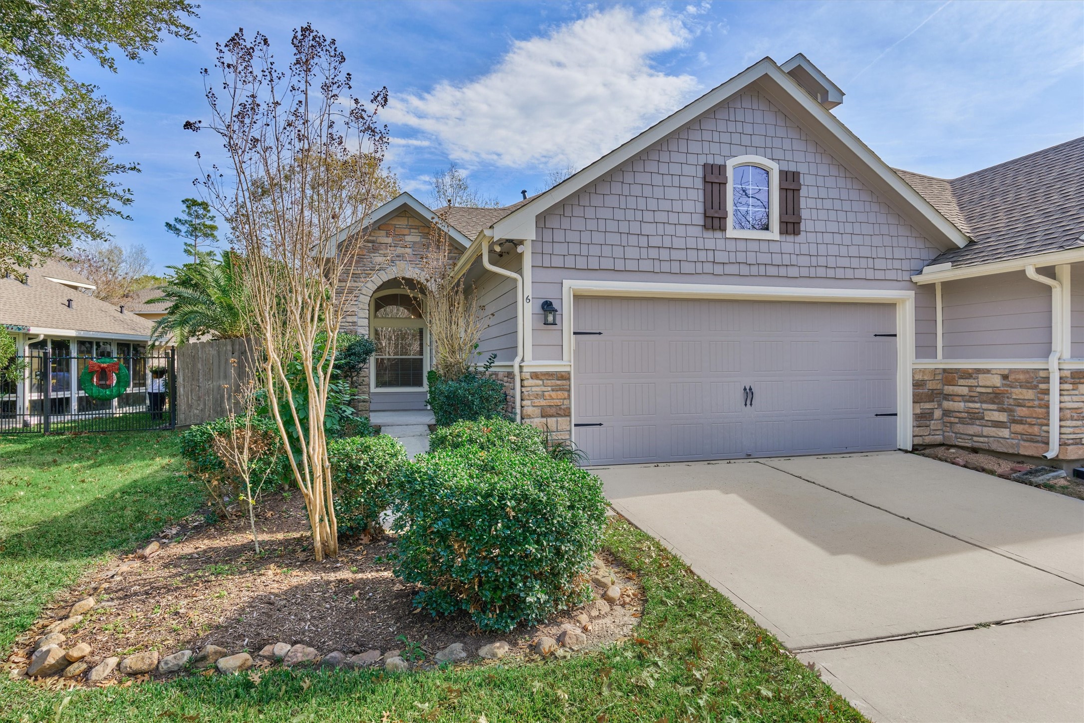 a front view of a house with a garden