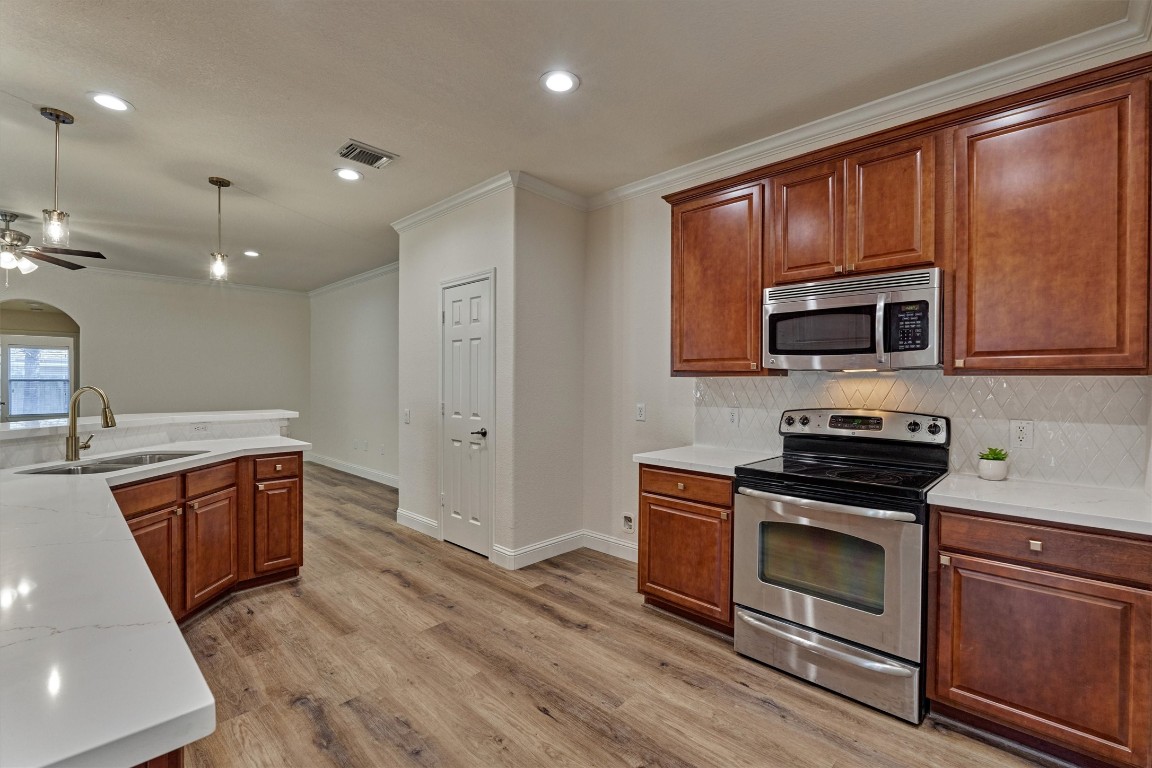 6 Windsor Bridge Drive Conroe, TX 77384 - Photo 11 of 46 The large kitchen with stunning new counters, modern new faucet, neutral tile backsplash along with all new lighting and hardware. There is gas in the home should you wish to add a gas stove.