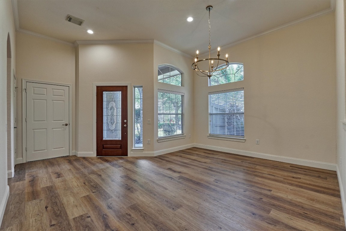 6 Windsor Bridge Drive Conroe, TX 77384 - Photo 12 of 46 The large dining room with large double pane windows, crown molding, fresh paint and beautiful new light fixtures.