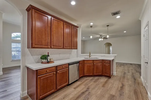 a view of a kitchen counter space and wooden floor
