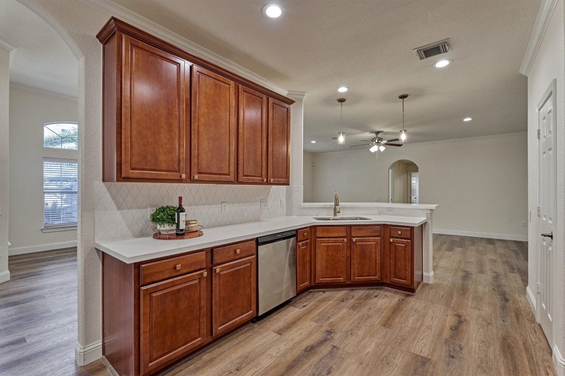 6 Windsor Bridge Drive Conroe, TX 77384 - Photo 14 of 46 The kitchen is beautiful!. Warm solid wood cabinetry with stunning new Quartz counters, backsplash and all new hardware and lighting! This kitchen shines!