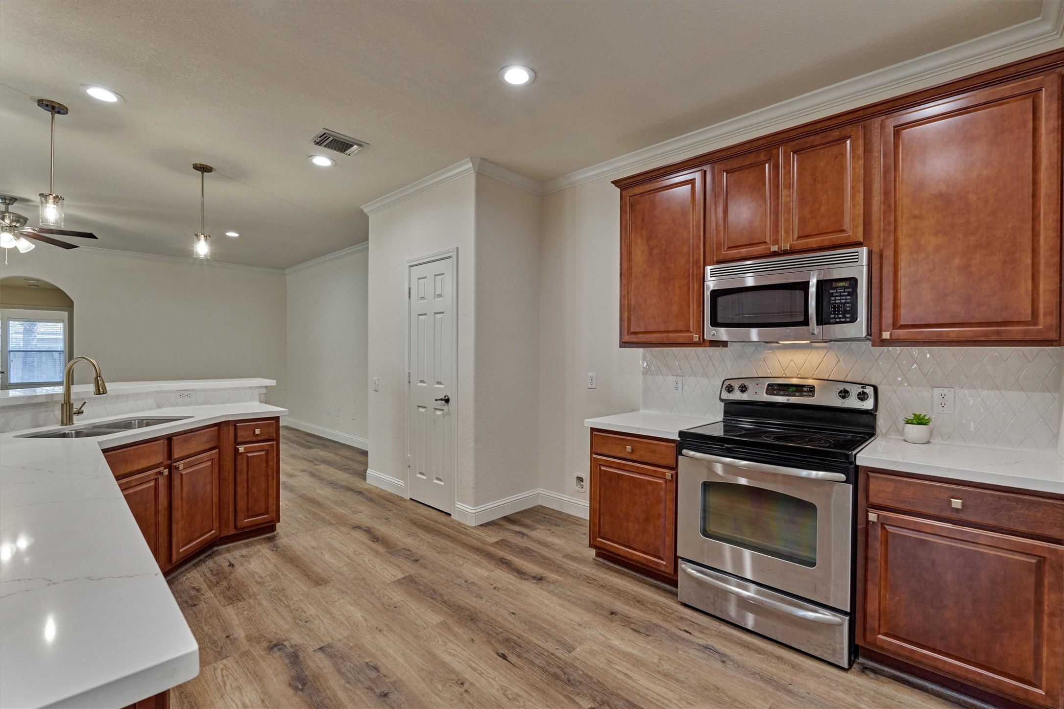 6 Windsor Bridge Drive Conroe, TX 77384 - Photo 15 of 46 a kitchen with wooden cabinets and stainless steel appliances
