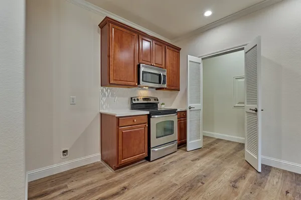 a view of kitchen with sink and stainless steel appliances