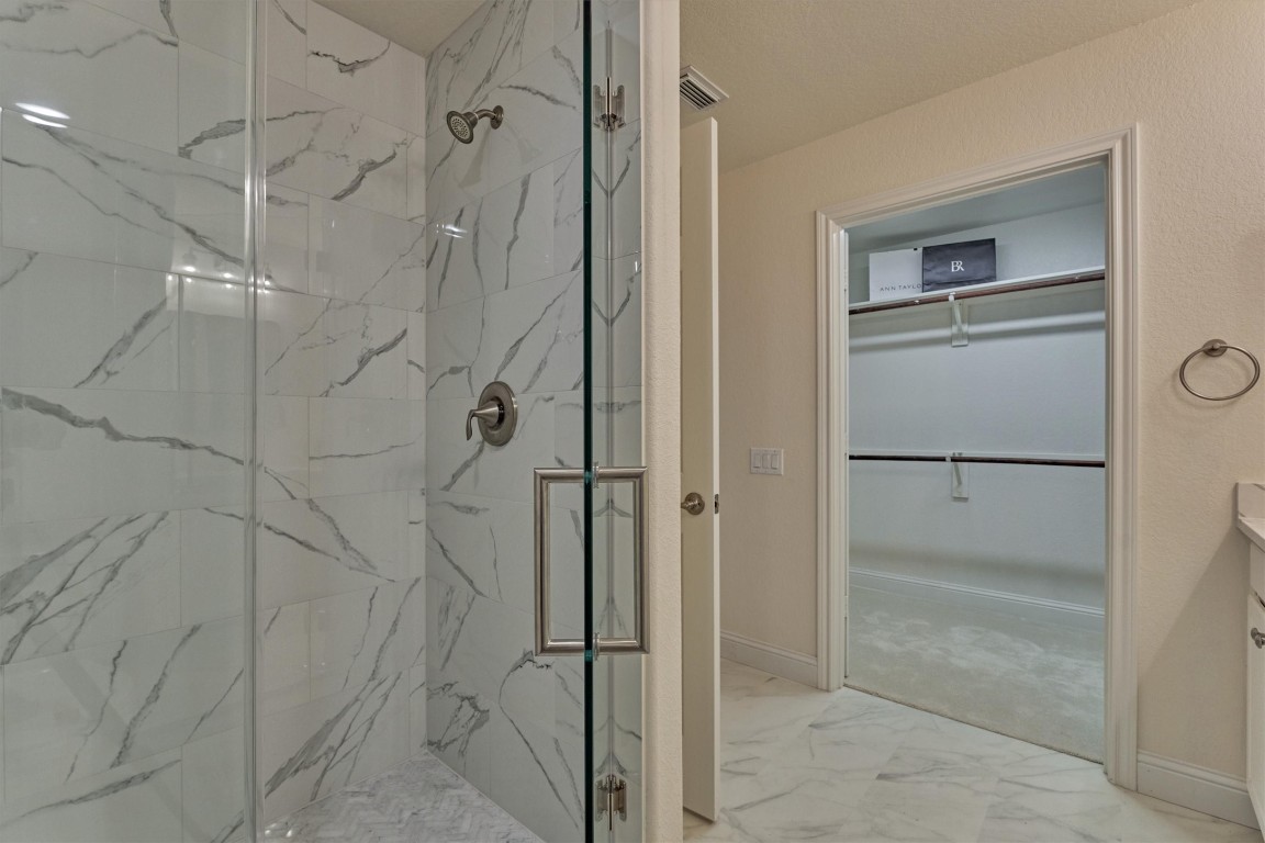 6 Windsor Bridge Drive Conroe, TX 77384 - Photo 20 of 46 The en-suite primary bathroom with all new oversize glass shower. The seller have added new modern tile flooring and it is immaculate throughout.