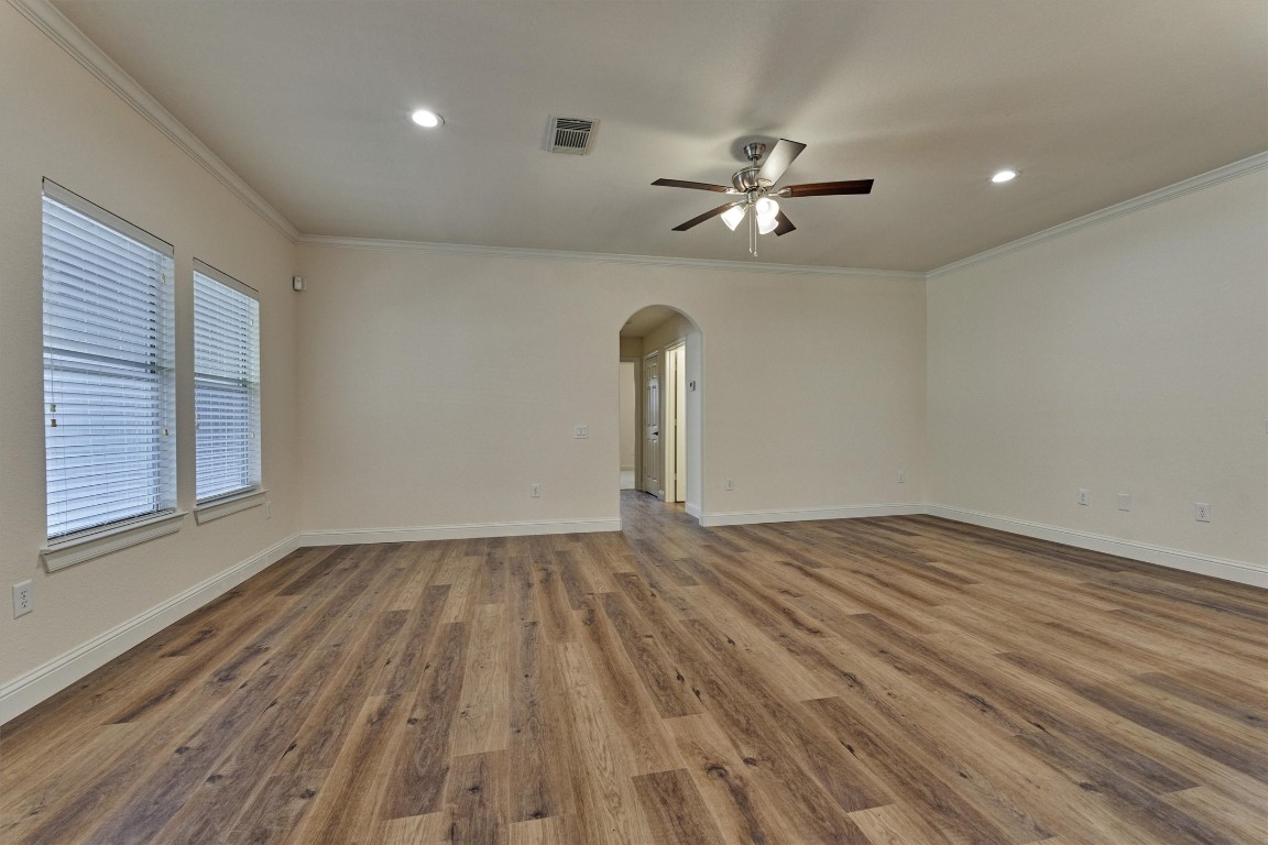 6 Windsor Bridge Drive Conroe, TX 77384 - Photo 22 of 46 The large family room with all new flooring, fresh paint and all newly added lighting and hardware! This is a lovely room with a door leading to the side yard covered patio.