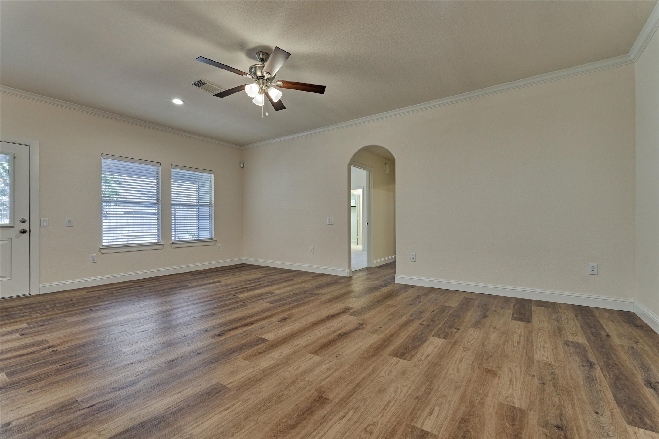 6 Windsor Bridge Drive Conroe, TX 77384 - Photo 22 of 46 an empty room with wooden floor chandelier fan and windows