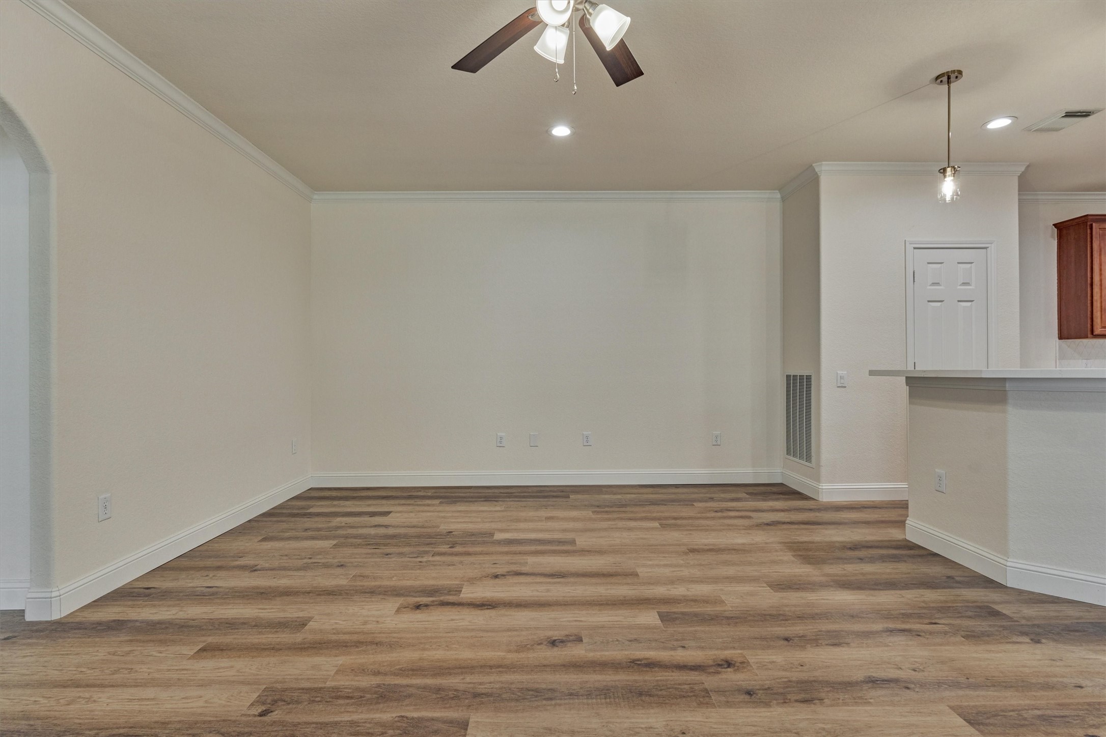 6 Windsor Bridge Drive Conroe, TX 77384 - Photo 25 of 46 a view of an empty room with wooden floor and fan