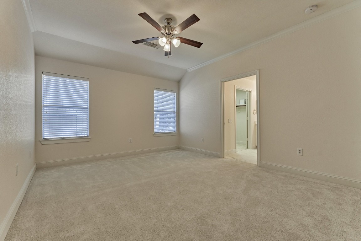 6 Windsor Bridge Drive Conroe, TX 77384 - Photo 26 of 46 The primary bedroom suite is very spacious, features crown molding, high ceilings, soft new carpet and freshly painted throughout.