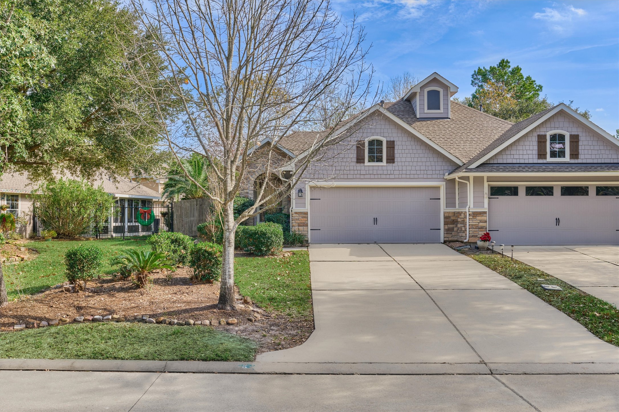 6 Windsor Bridge Drive Conroe, TX 77384 - Photo 3 of 46 a front view of a house with a yard and a garage