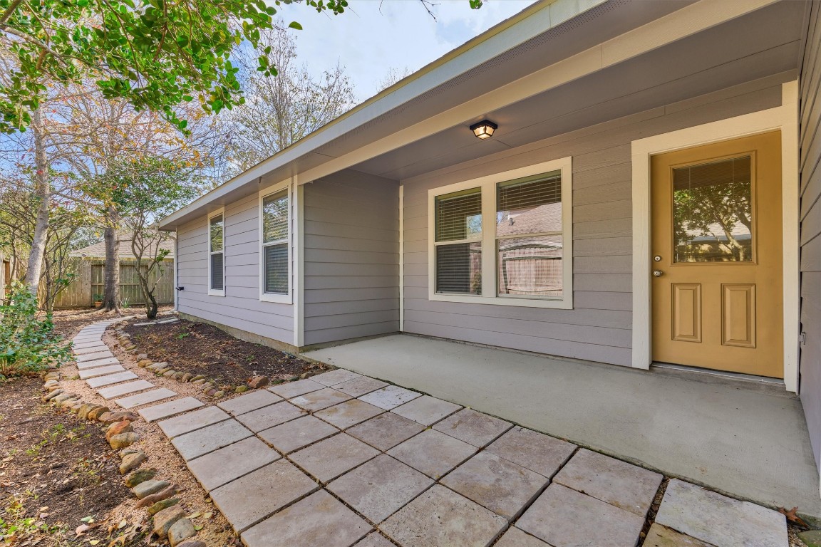 6 Windsor Bridge Drive Conroe, TX 77384 - Photo 32 of 46 The side yard patio offers some escape from the hot Houston Sun and has ample space for outdoor dining and relaxation.