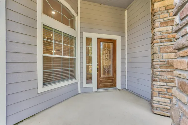 an aerial view of residential houses with outdoor space and trees