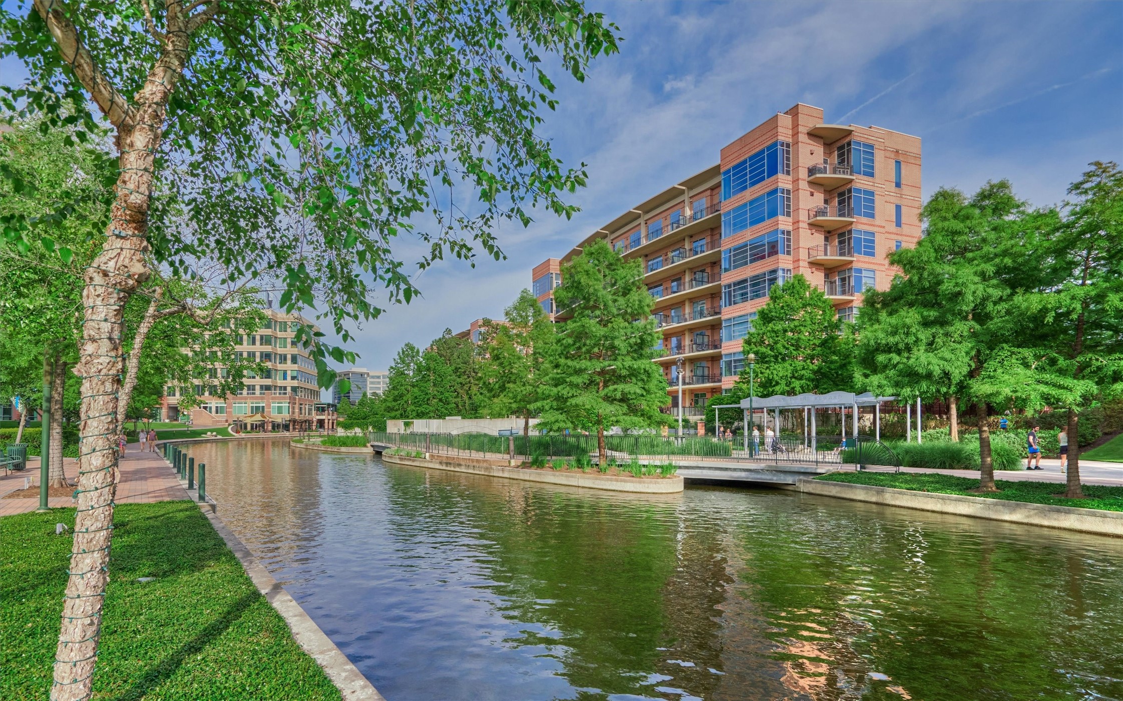 6 Windsor Bridge Drive Conroe, TX 77384 - Photo 45 of 46 a view of building with river in front of it