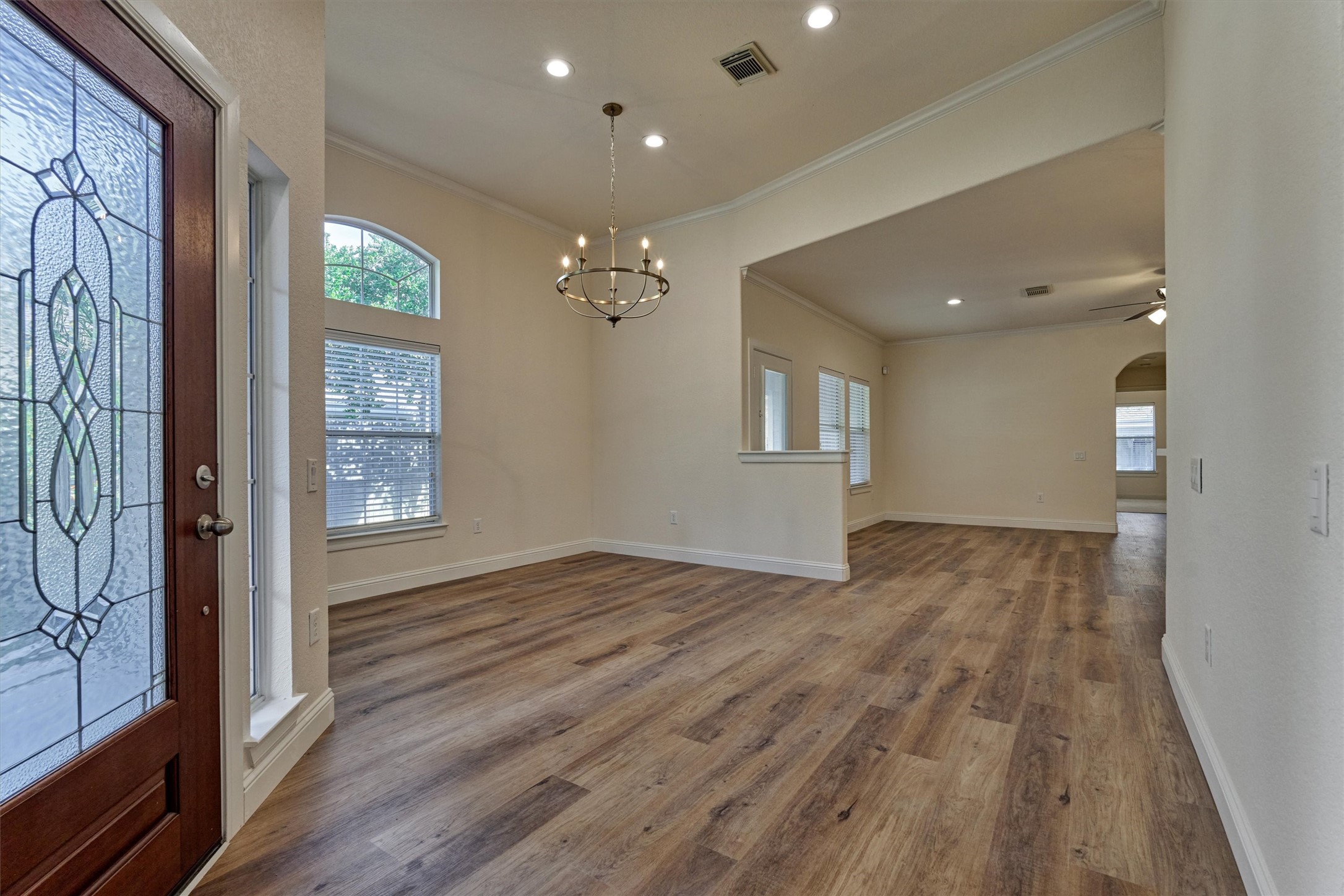 6 Windsor Bridge Drive Conroe, TX 77384 - Photo 9 of 46 a view of an empty room with glass door and wooden floor