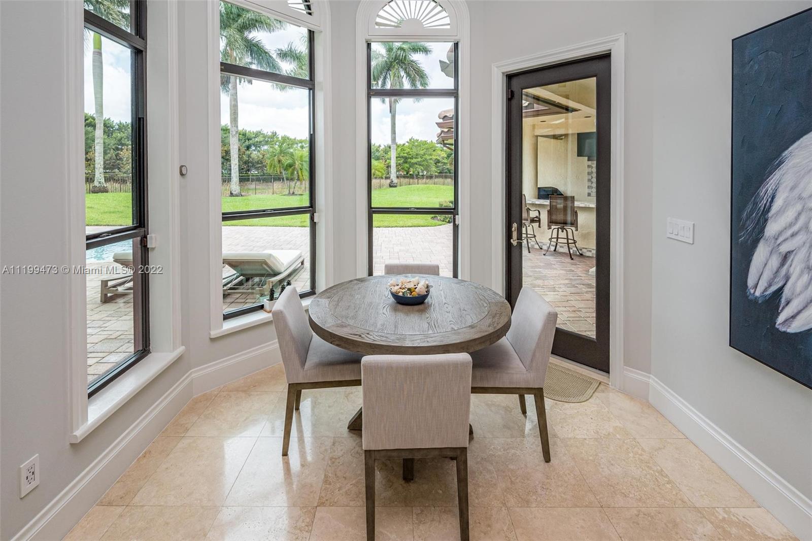 3510 Windmill Ranch Road Weston, FL 33331 - Photo 18 of 59 a view of a dining room with furniture and a window