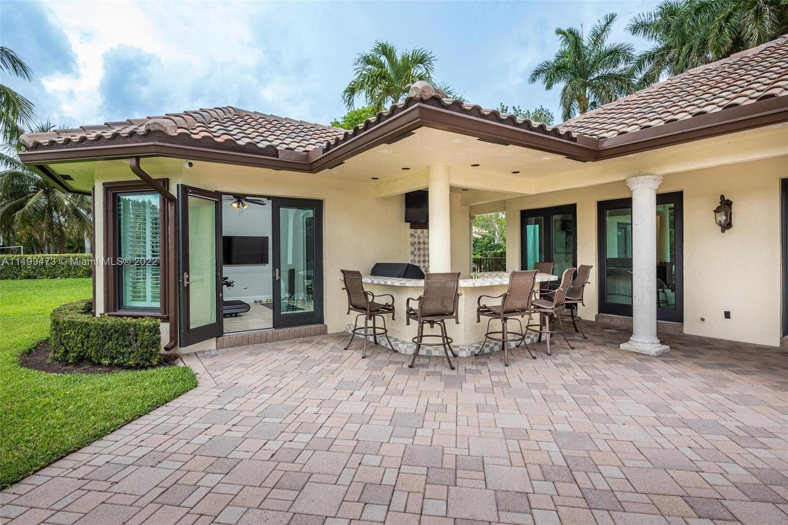 3510 Windmill Ranch Road Weston, FL 33331 - Photo 42 of 59 a view of a patio with table and chairs