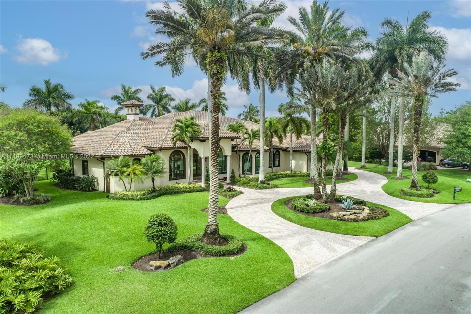3510 Windmill Ranch Road Weston, FL 33331 - Photo 5 of 59 a front view of a house with garden and patio