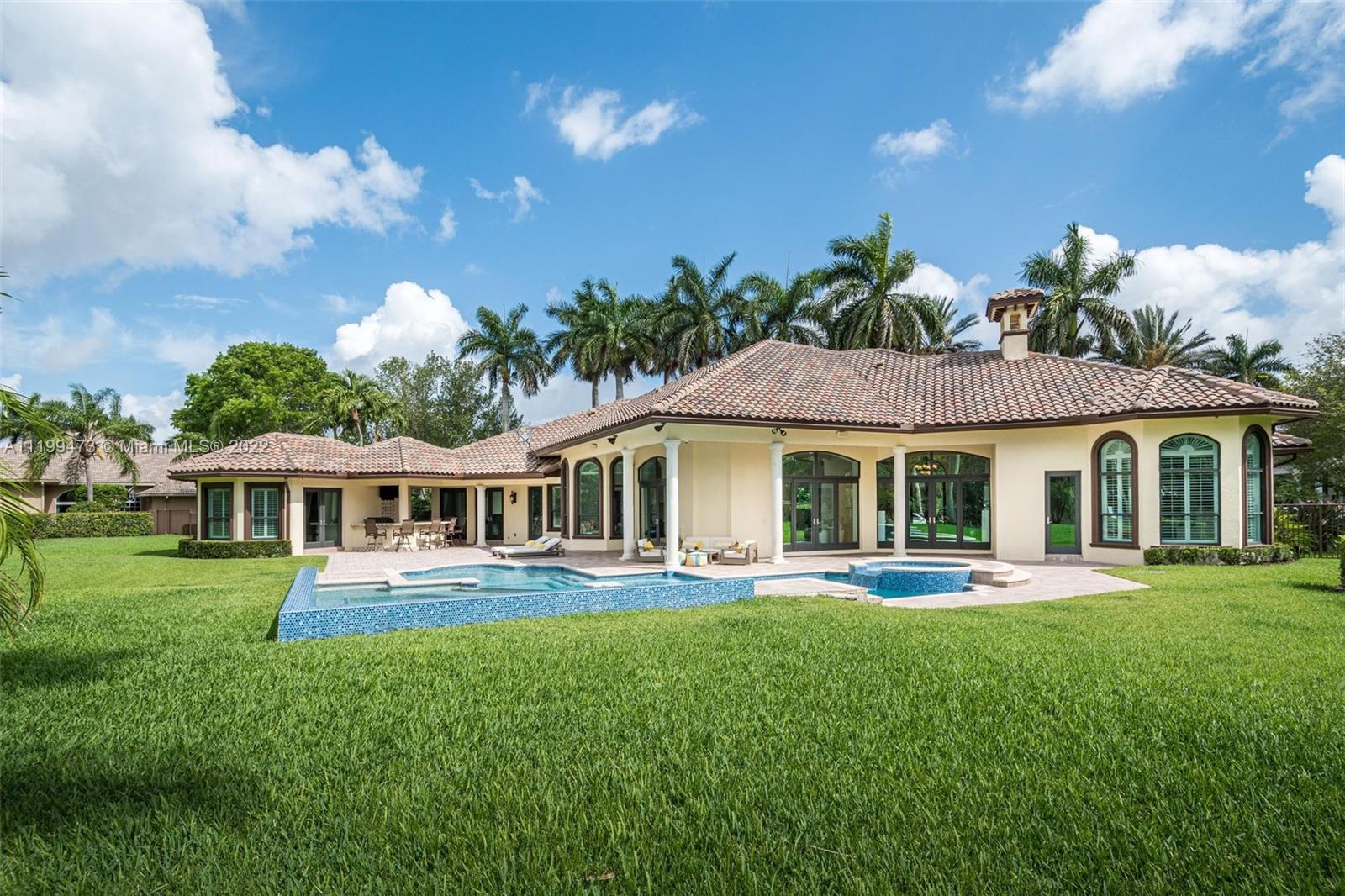3510 Windmill Ranch Road Weston, FL 33331 - Photo 56 of 59 a front view of a house with a yard table and chairs