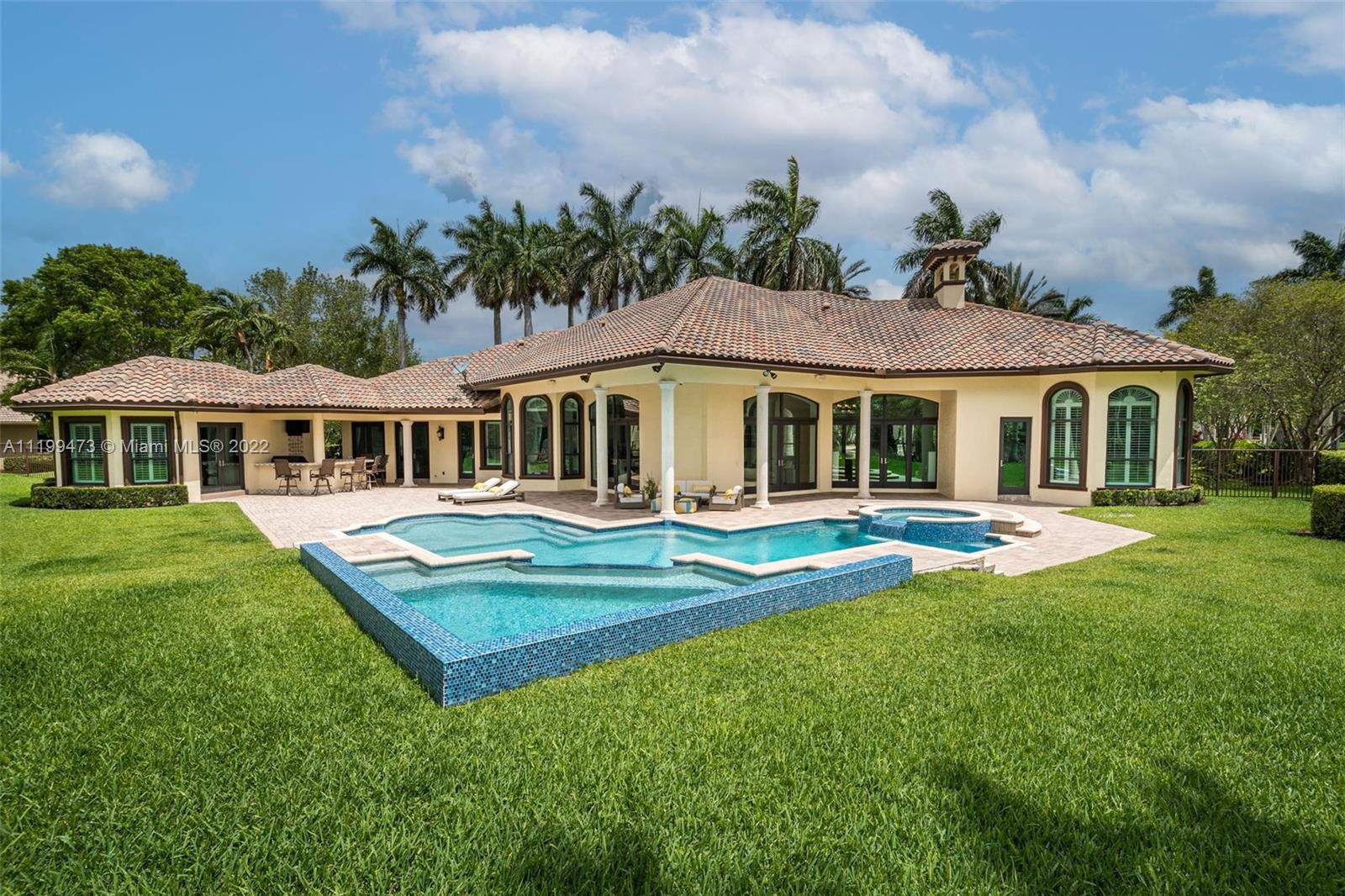 3510 Windmill Ranch Road Weston, FL 33331 - Photo 58 of 59 a view of a house with a yard table and chairs