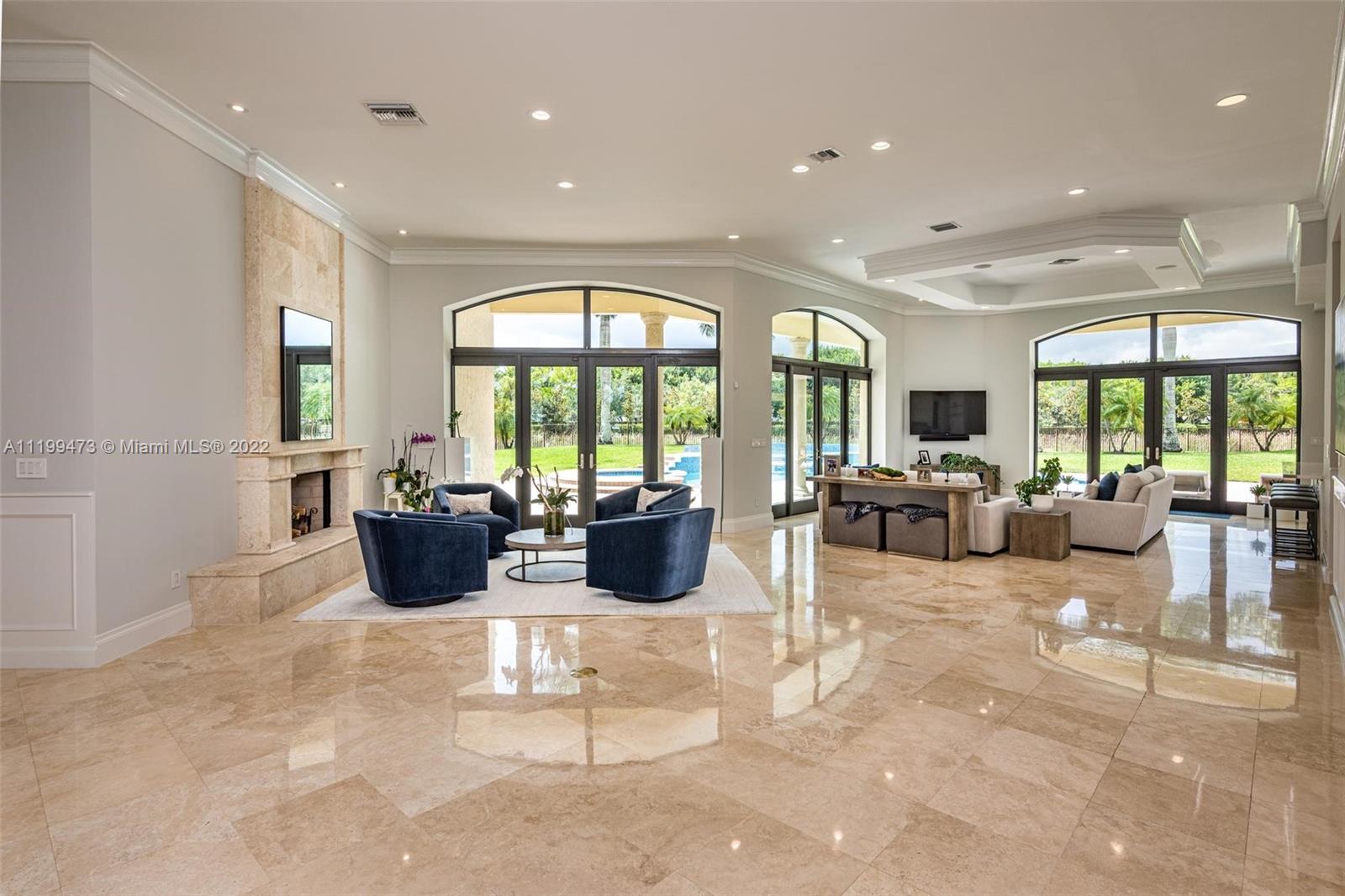 3510 Windmill Ranch Road Weston, FL 33331 - Photo 9 of 59 a living room with furniture fireplace and large windows