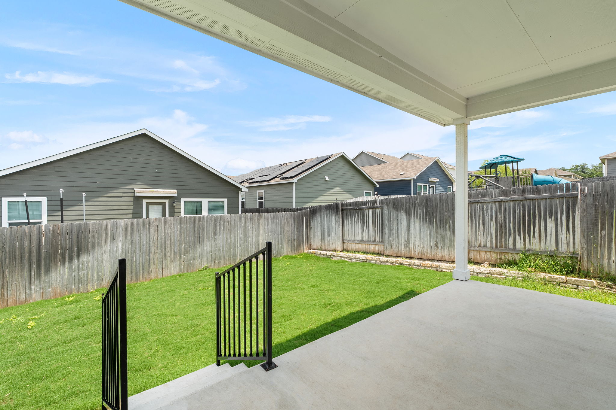 313 Mclintock Road Jarrell, TX 76537 - Photo 28 of 40 A spacious backyard with a private fence, verdant lawn, and a covered patio for outdoor relaxation.